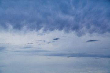 Blue clouds in the sky cover the sky, a dramatic sky in blue tones, blur