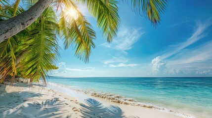 Pristine beach with clear turquoise water and lush green hills under a bright sky, providing a perfect tropical paradise