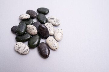 Multi-colored colored stones pebbles on a colored background. Background for banner, backdrop or texture