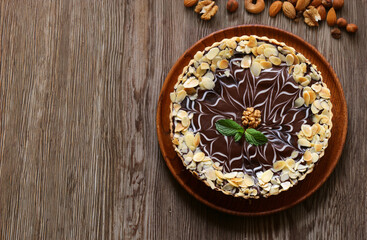 cake with nuts and chocolate on a wooden table