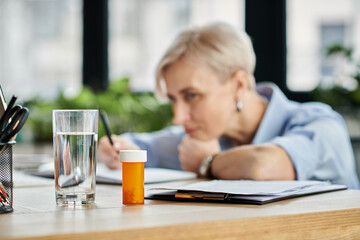A middle-aged businesswoman with short hair is deep in thought while feeling unwell during menopause