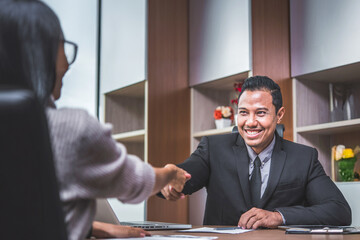 Happy businessman and businesswoman with business handshake for successful of investment deal. Business cooperation and partnership in financial and marketing concept