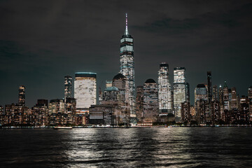 Obraz premium Night in The NYC city, USA, United States. Night day with iconic buildings. New York City NYC Manhattan Downtown Skyline, viewed from Jersey City, USA.