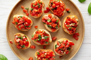 Homemade Italian Tomato Bruschetta on a Plate, top view. Flat lay, overhead, from above.