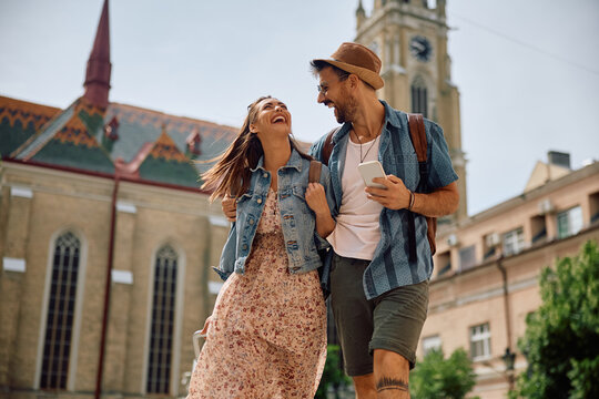Cheerful couple having fun while traveling together in summer.