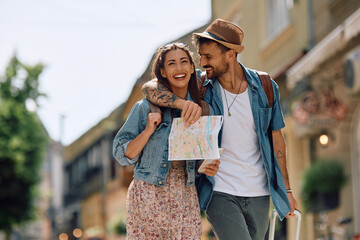 Happy couple of tourists enjoying in their summer travel.