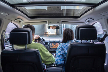 Man and woman traveling in car, sitting in car driving to travel destination.