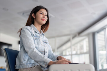 Young Female Tourist Waiting at Modern Airport Terminal with Natural Light and Contemporary Design