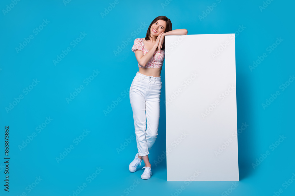 Poster Photo of cute nice pretty lady stylish clothes hand hold big placard banner demonstrate empty space isolated on blue color background