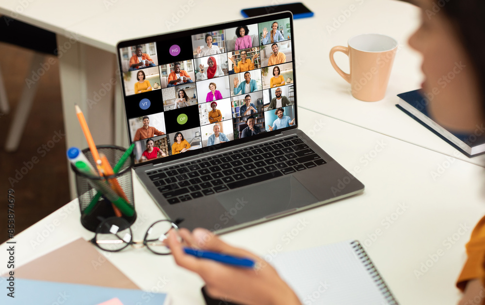 Poster A laptop screen displays a video conference call with multiple participants of various backgrounds and ethnicities, all appearing in separate video squares.