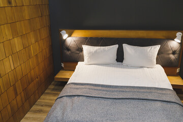 A bed with white pillows and a made-up bed in a hotel. Clean bed.