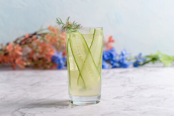A refreshing cucumber mocktail made with thinly sliced cucumbers, lemonade and garnished with dill.