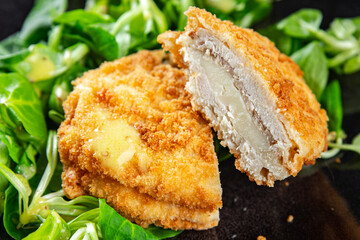 cutlet cordon bleu chicken meat, ham, cheese natural fresh appetizer meal food snack on the table copy space food background rustic top view