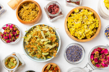 Assortment of dry herbal and berry tea on a wooden background. Tea party concept. medicinal herbs. Healing herbs.Alternative medicine.Linden, calendula, cornflowers, marigold, tansy, tea rose.
