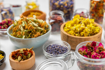 Assortment of dry herbal and berry tea on a wooden background. Tea party concept. medicinal herbs. Healing herbs.Alternative medicine.Linden, calendula, cornflowers, marigold, tansy, tea rose.