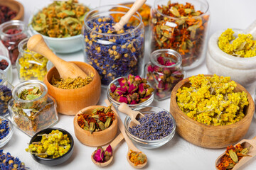 Assortment of dry herbal and berry tea on a wooden background. Tea party concept. medicinal herbs. Healing herbs.Alternative medicine.Linden, calendula, cornflowers, marigold, tansy, tea rose.