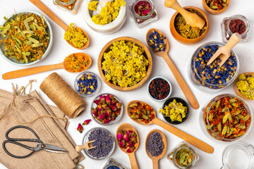 Assortment of dry herbal and berry tea on a wooden background. Tea party concept. medicinal herbs. Healing herbs.Alternative medicine.Linden, calendula, cornflowers, marigold, tansy, tea rose.