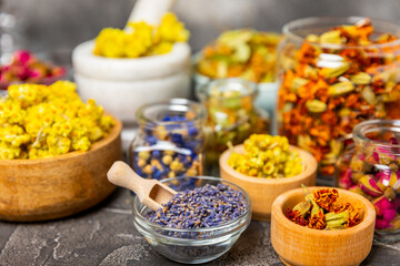 Assortment of dry herbal and berry tea on a wooden background. Tea party concept. medicinal herbs. Healing herbs.Alternative medicine.Linden, calendula, cornflowers, marigold, tansy, tea rose.