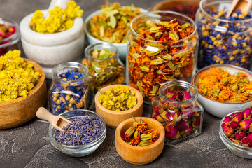 Assortment of dry herbal and berry tea on a wooden background. Tea party concept. medicinal herbs. Healing herbs.Alternative medicine.Linden, calendula, cornflowers, marigold, tansy, tea rose.