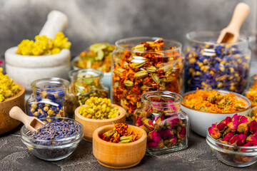 Assortment of dry herbal and berry tea on a wooden background. Tea party concept. medicinal herbs. Healing herbs.Alternative medicine.Linden, calendula, cornflowers, marigold, tansy, tea rose.