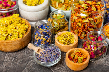 Assortment of dry herbal and berry tea on a wooden background. Tea party concept. medicinal herbs. Healing herbs.Alternative medicine.Linden, calendula, cornflowers, marigold, tansy, tea rose.