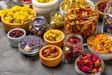 Assortment of dry herbal and berry tea on a wooden background. Tea party concept. medicinal herbs. Healing herbs.Alternative medicine.Linden, calendula, cornflowers, marigold, tansy, tea rose.