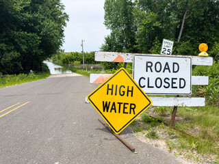 High Water Road Closed warning signs on flooded road