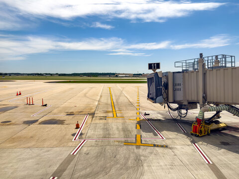 Apron of airport with jetway viewed from the passenger terminal