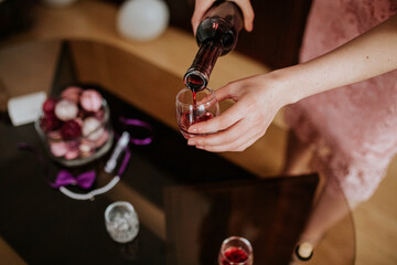 A close-up shot of a drink being poured into a glass, capturing the liquid in motion and highlighting the rich color and texture of the beverage.