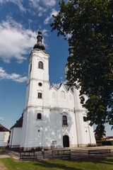 This image shows a picturesque church with its architectural details highlighted against a clear blue sky, creating a serene and peaceful scene. 