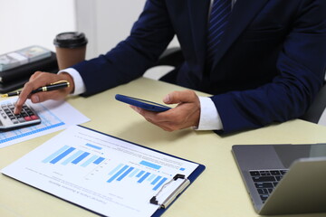 Looking at busy businessman's hands Using smartphones and laptops in the office, AI creates images.