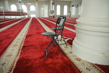 Jambi, Indonesia - June 7th 2024: Iron folding chairs in mosques are used to help worshipers who cannot stand during prayer