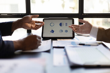 Business people meeting discuss project plan and finance results in office. Businessman financial advisor analyzing the financial data graph and charts on the tablet screen.