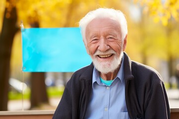 
Elderly man smiling with Parkinson's Awareness Month banner in the background