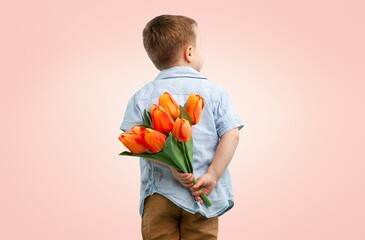 Cute charming child holds a bouquet of flowers