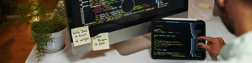 Web banner with programming code on screen of laptop and computer