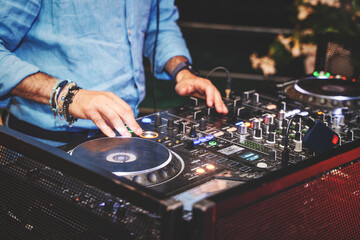 DJ Mixing Music at Nightclub with Professional Equipment - Energetic Nightlife Scene
