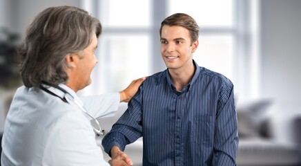 Portrait of young patient with doctor during consultation