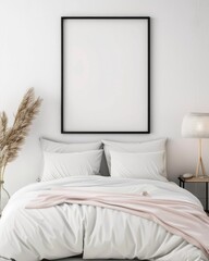Cozy minimalist bedroom with white bedding, blank picture frame, and a bedside lamp. Comfortable and stylish interior design inspiration.