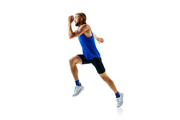 Focused and motivated young man, competitive athlete in motion, running, preparing for competition isolated on white background. Concept of sport, marathon, competition, healthy and active lifestyle