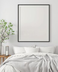 Minimalistic bedroom with blank picture frame, cozy bed with white linens, side table and plant, perfect for home decor inspiration.