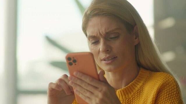 Face sad attractive woman hold use smartphone sitting at home. Scrolling social media. Camera moving around. 360 degrees