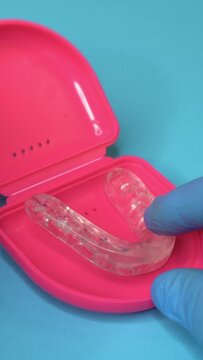 Doctor Putting a Dental splint or dental aligner.Bruxism can be treated with night guard teeth and dental splints.