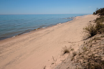 Looking down the beach and Lake Michigan from the main parking area at Point Beach State Foreset, Two Rivers, Wisconsin in early May 2024 - no stones along beach