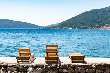 chairs on the beach overlooking bay of kotor