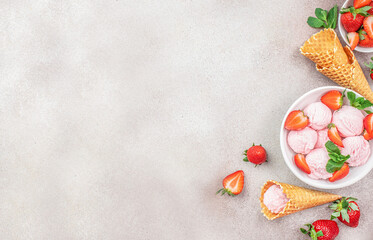 strawberry ice cream scoop ingredients in a bowl, ice cream cones, spoon. Top view