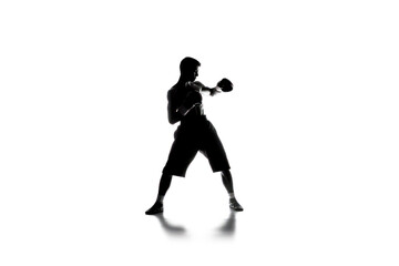 A man is boxing in a white background. The image has a strong and athletic feel to it, with the man's pose