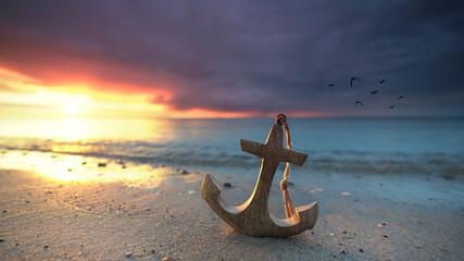 sunset beach with wooden anchor
