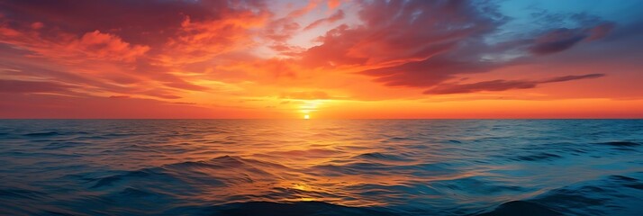 sunset over the ocean with a dark cloud and orange sky