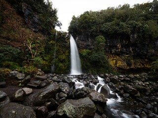 Long exposure of Dawson Falls Te Rere O Kapuni waterfall on the lush green bush slopes of Mount Taranaki New Zealand